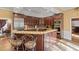 Gourmet kitchen features a breakfast bar, wine cooler, granite countertops, custom cabinetry, and stainless steel appliances at 440 Dix Lee On Dr., Fayetteville, GA 30215