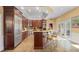 Spacious kitchen featuring an island with seating, custom cabinets, stainless steel appliances, and access to outdoor deck at 440 Dix Lee On Dr., Fayetteville, GA 30215