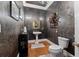 Stylish powder room with unique wallpaper, elegant fixtures, and a pedestal sink for a touch of sophistication at 440 Dix Lee On Dr., Fayetteville, GA 30215