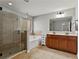 Bright bathroom features a separate glass shower, soaking tub and double vanity at 1570 Lenox Overlook Ne Rd, Atlanta, GA 30329