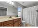 Bathroom features neutral colors with tile floor and shower curtain at 1570 Lenox Overlook Ne Rd, Atlanta, GA 30329