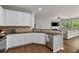 Open kitchen features stainless appliances, breakfast bar and opens to living room with hardwood flooring throughout at 1570 Lenox Overlook Ne Rd, Atlanta, GA 30329