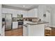 Bright kitchen boasts white cabinets, stainless steel appliances, granite counters, and a breakfast bar at 1570 Lenox Overlook Ne Rd, Atlanta, GA 30329