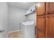 Well-lit laundry room with a white washer and dryer, complemented by ample cabinet space at 1570 Lenox Overlook Ne Rd, Atlanta, GA 30329