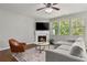 Cozy living room with a fireplace, TV, and large windows, providing natural light at 1570 Lenox Overlook Ne Rd, Atlanta, GA 30329