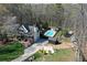Aerial view of the house, pool, and multiple outbuildings surrounded by trees at 158 Lambeth Dr, Hiram, GA 30141