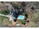 Overhead shot of the property with a refreshing pool and outbuildings amid wooded surroundings at 158 Lambeth Dr, Hiram, GA 30141
