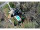 Bird's eye view of the home, pool, outbuildings, and lush greenery, offering a tranquil setting at 158 Lambeth Dr, Hiram, GA 30141
