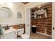 Updated bathroom with a round mirror, new vanity, and wood accent wall with storage at 158 Lambeth Dr, Hiram, GA 30141