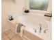 Relaxing bathtub with decorative window and upgraded faucet fixtures perfect for a relaxing bath at 158 Lambeth Dr, Hiram, GA 30141