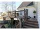 Wooden deck with stairs, decorative railing, and wooded view in the background at 158 Lambeth Dr, Hiram, GA 30141