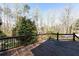 Stained wooden deck with decorative railing overlooking the backyard with trees and foliage at 158 Lambeth Dr, Hiram, GA 30141