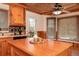 Kitchen island with cabinetry, breakfast items, back splash, and view of the window at 158 Lambeth Dr, Hiram, GA 30141