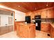 Open kitchen featuring a wood ceiling, center island, black appliances, and light wood cabinetry at 158 Lambeth Dr, Hiram, GA 30141