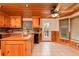 View of the kitchen with wood ceiling, center island, tile floors, and deck access at 158 Lambeth Dr, Hiram, GA 30141