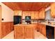Kitchen with light wood cabinets, black appliances, a tiled backsplash, and a center island at 158 Lambeth Dr, Hiram, GA 30141