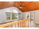 Spacious living room with vaulted wood ceilings, a ceiling fan, and large windows for ample natural light at 158 Lambeth Dr, Hiram, GA 30141
