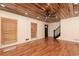 Bright living room with hardwood floors, wood plank ceiling, and staircase at 158 Lambeth Dr, Hiram, GA 30141