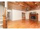 Inviting living room with wood-burning fireplace, hardwood floors and wooden ceiling at 158 Lambeth Dr, Hiram, GA 30141