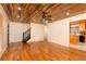 Bright living room with hardwood floors, wooden ceiling, stairs, and open access to the kitchen at 158 Lambeth Dr, Hiram, GA 30141
