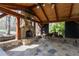 An outdoor stone pavilion with fireplace and wooded view is perfect for entertaining at 158 Lambeth Dr, Hiram, GA 30141