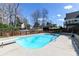 Backyard pool features a diving board and ladder for access, wooden fence, and home in the background, creating a private oasis at 158 Lambeth Dr, Hiram, GA 30141