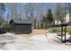 The dark storage shed, accompanied by trees and wooden fence, provides functional space for storing yard equipment at 158 Lambeth Dr, Hiram, GA 30141