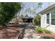 Stone walkway leads to open-air wood structure with chimney in a private backyard setting at 158 Lambeth Dr, Hiram, GA 30141