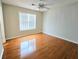 Bedroom with hardwood floors, ceiling fan, and window for natural light at 1822 Hayden Mill Ct, Lawrenceville, GA 30043