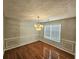 Traditional dining room with hardwood floors, chandelier, and large window at 1822 Hayden Mill Ct, Lawrenceville, GA 30043