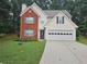 Charming two-story home with brick facade, light siding, manicured lawn, and a two-car garage at 1822 Hayden Mill Ct, Lawrenceville, GA 30043