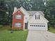 Charming two-story home with brick facade, light siding, manicured lawn, and a two-car garage at 1822 Hayden Mill Ct, Lawrenceville, GA 30043