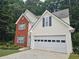 Charming two-story home with brick facade, light siding, manicured lawn, and a two-car garage at 1822 Hayden Mill Ct, Lawrenceville, GA 30043