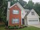 Charming two-story home with a brick and siding exterior, manicured lawn, and an attached two-car garage at 1822 Hayden Mill Ct, Lawrenceville, GA 30043