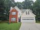 Charming two-story home with brick facade, light siding, manicured lawn, and a two-car garage at 1822 Hayden Mill Ct, Lawrenceville, GA 30043