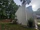 View of the side and back of the home, showing the vinyl siding and brick chimney at 1822 Hayden Mill Ct, Lawrenceville, GA 30043