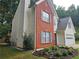 Charming two-story home with a brick and siding exterior, manicured lawn, and an attached two-car garage at 1822 Hayden Mill Ct, Lawrenceville, GA 30043
