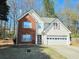 Charming two-story home with a brick and white siding facade and attached two-car garage at 1822 Hayden Mill Ct, Lawrenceville, GA 30043