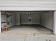 View of a clean, two-car garage with a ceiling fan and a door leading to the backyard at 1822 Hayden Mill Ct, Lawrenceville, GA 30043