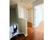 Hallway with hardwood floors leading to bedrooms and the front door at 1822 Hayden Mill Ct, Lawrenceville, GA 30043