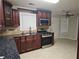 This beautiful kitchen features dark wood cabinets, stainless steel appliances, and granite countertops at 1822 Hayden Mill Ct, Lawrenceville, GA 30043