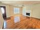 Bright living room featuring hardwood floors, fireplace, and large window at 1822 Hayden Mill Ct, Lawrenceville, GA 30043