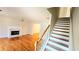 Bright living room with hardwood floors, fireplace, ceiling fan, and staircase at 1822 Hayden Mill Ct, Lawrenceville, GA 30043