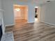 Spacious living area with wood-look floors flows into dining and kitchen areas for easy entertaining at 1822 Hayden Mill Ct, Lawrenceville, GA 30043