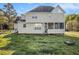 Backyard featuring a lawn, a screened-in porch, and light beige siding at 2275 Holly Run Dr, Jonesboro, GA 30236