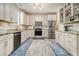 Well-lit kitchen with granite countertops, stainless steel appliances, and ample cabinet space at 2275 Holly Run Dr, Jonesboro, GA 30236