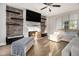 Inviting living room with modern fireplace, floating shelves, and wood flooring at 2275 Holly Run Dr, Jonesboro, GA 30236