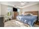 Spacious main bedroom with tray ceiling, ceiling fan, natural light, and a lovely headboard at 2275 Holly Run Dr, Jonesboro, GA 30236