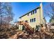 Exterior of a two-story house with a wooden deck and stairs leading to the yard filled with deciduous trees at 3876 Toccoa Falls Dr, Duluth, GA 30097