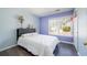 Comfortable bedroom with a large window and light blue walls at 3876 Toccoa Falls Dr, Duluth, GA 30097